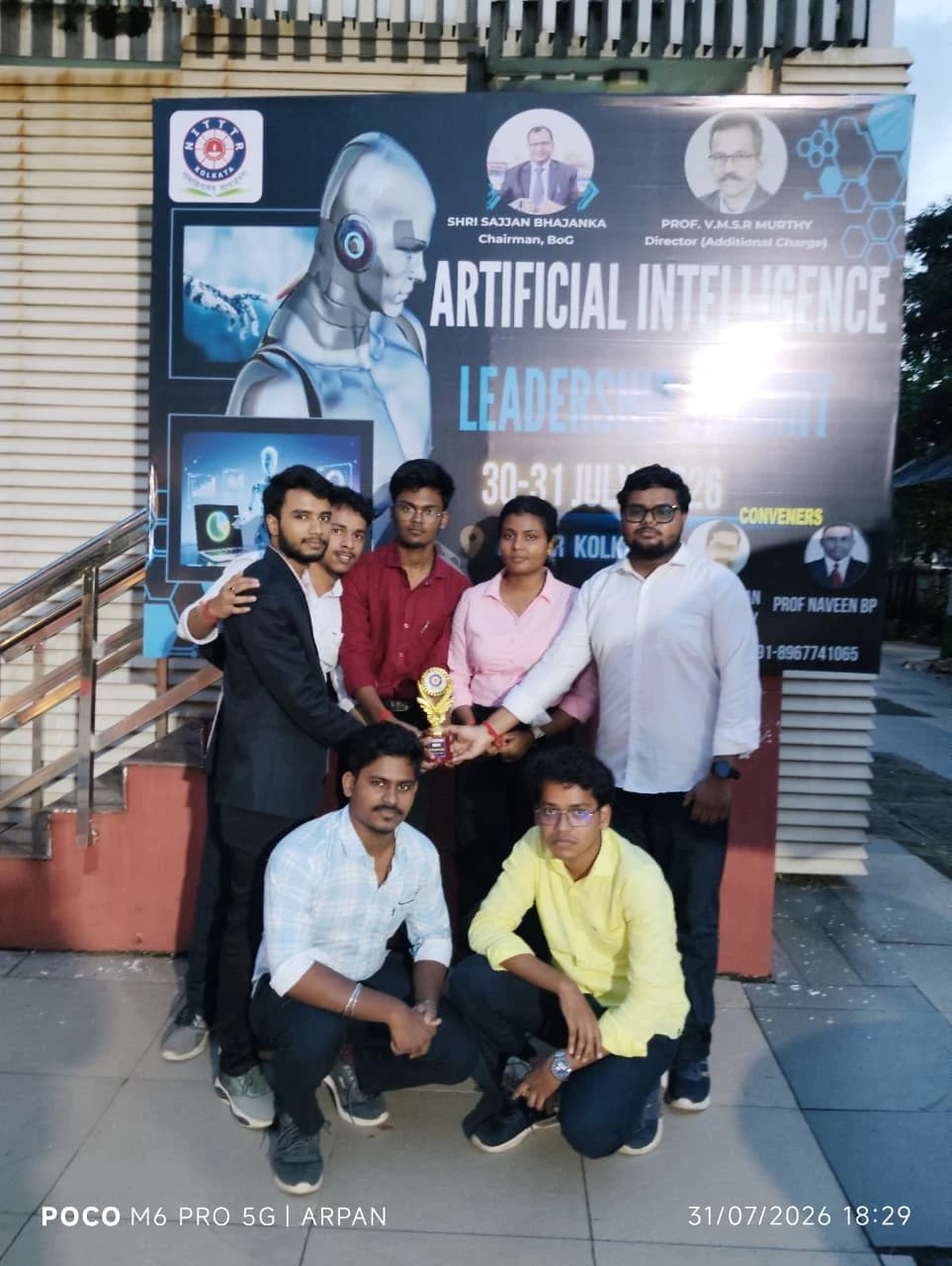 Team INDROVE, all seven SVIST Mechanical Engineering members, with their 2nd prize trophy in front of the AI Leadership Summit 2026 banner at NITTTR Kolkata